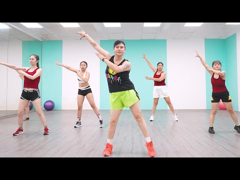 Woman doing an 18-minute Zumba dance workout at home for weight loss